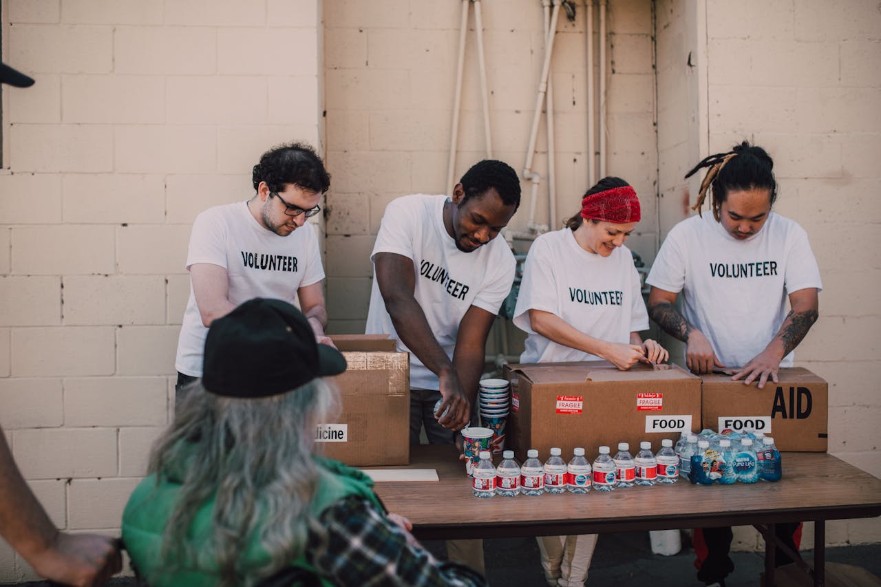 about-us Group of volunteers organizing and distributing aid packages and bottled water outdoors.